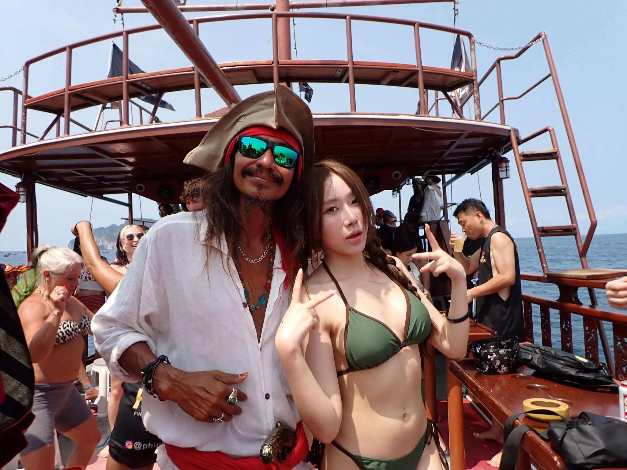 A pirate crew member and a guest on the deck of the Pirate Boat